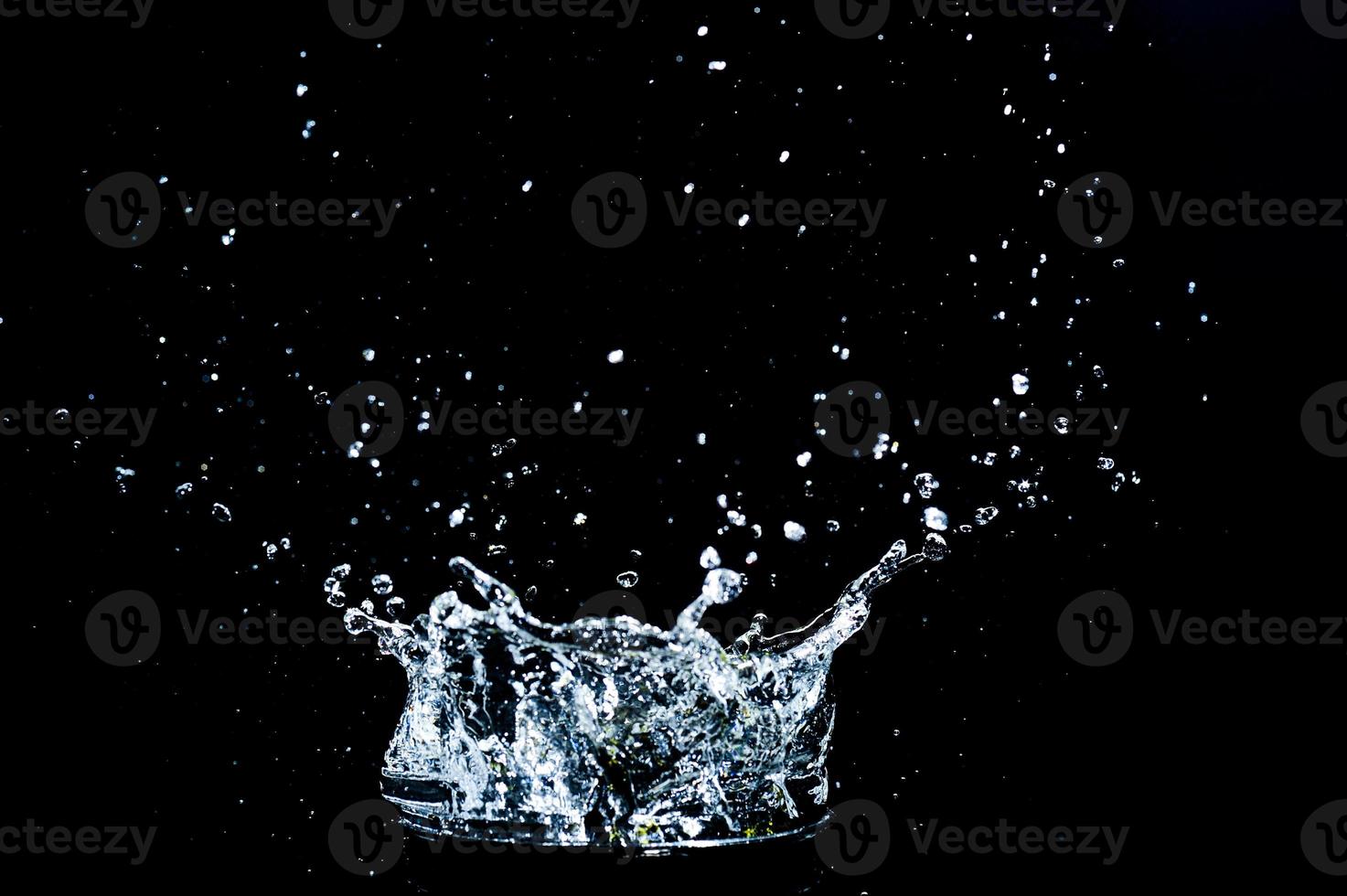 Scattered water splashes on a black background. water splash isolated on the black background photo