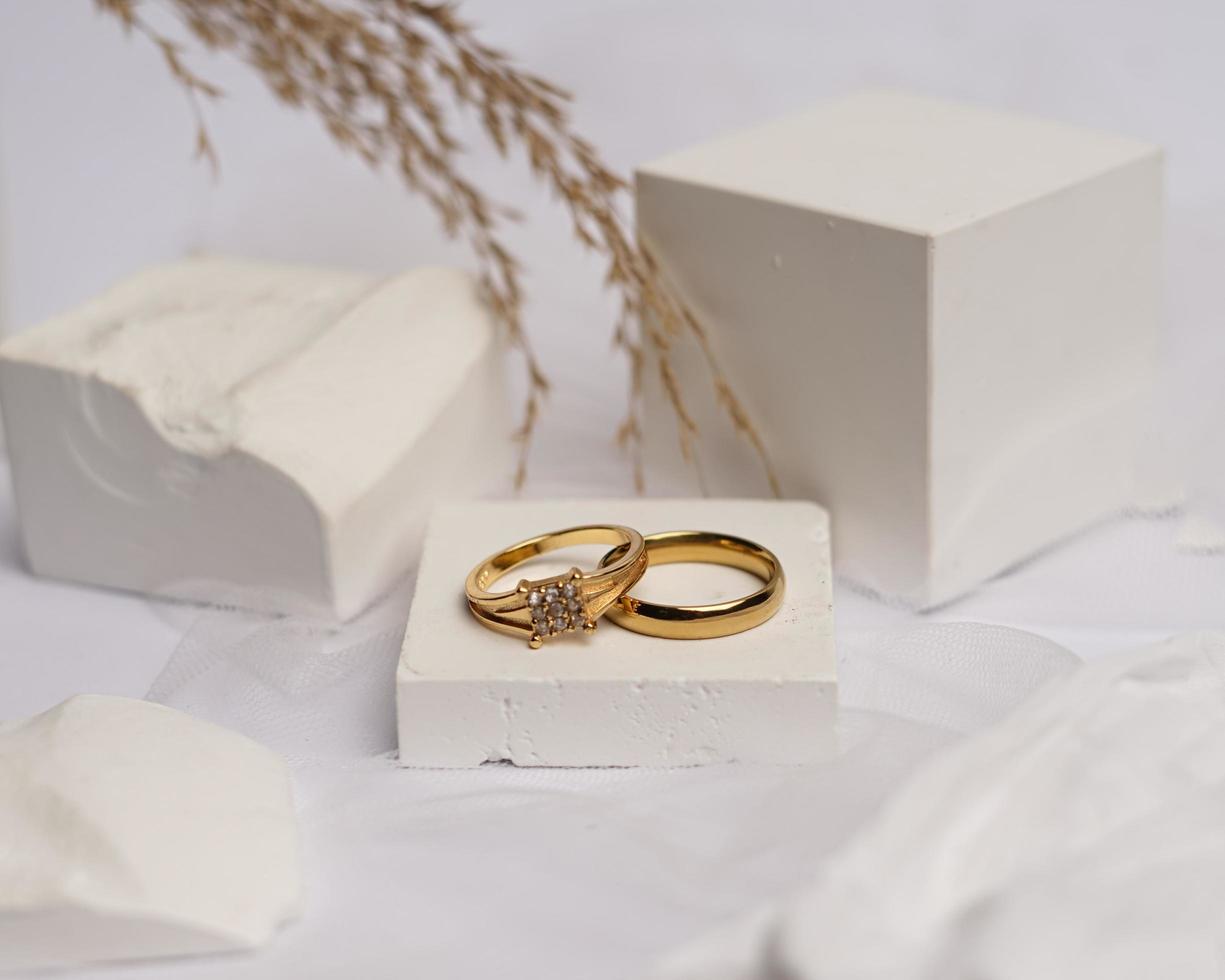 Wedding ring set on white stone. The jewelry ring is ready to be showcased and sold. The wedding ring is a sign of the love of the couple. Pearls and diamonds complete the ring's beauty. focus blur. photo