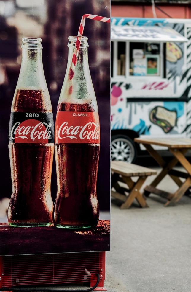 Minsk, Belarus, June 2022- refrigerator with  classic Coca-Cola bottle. photo