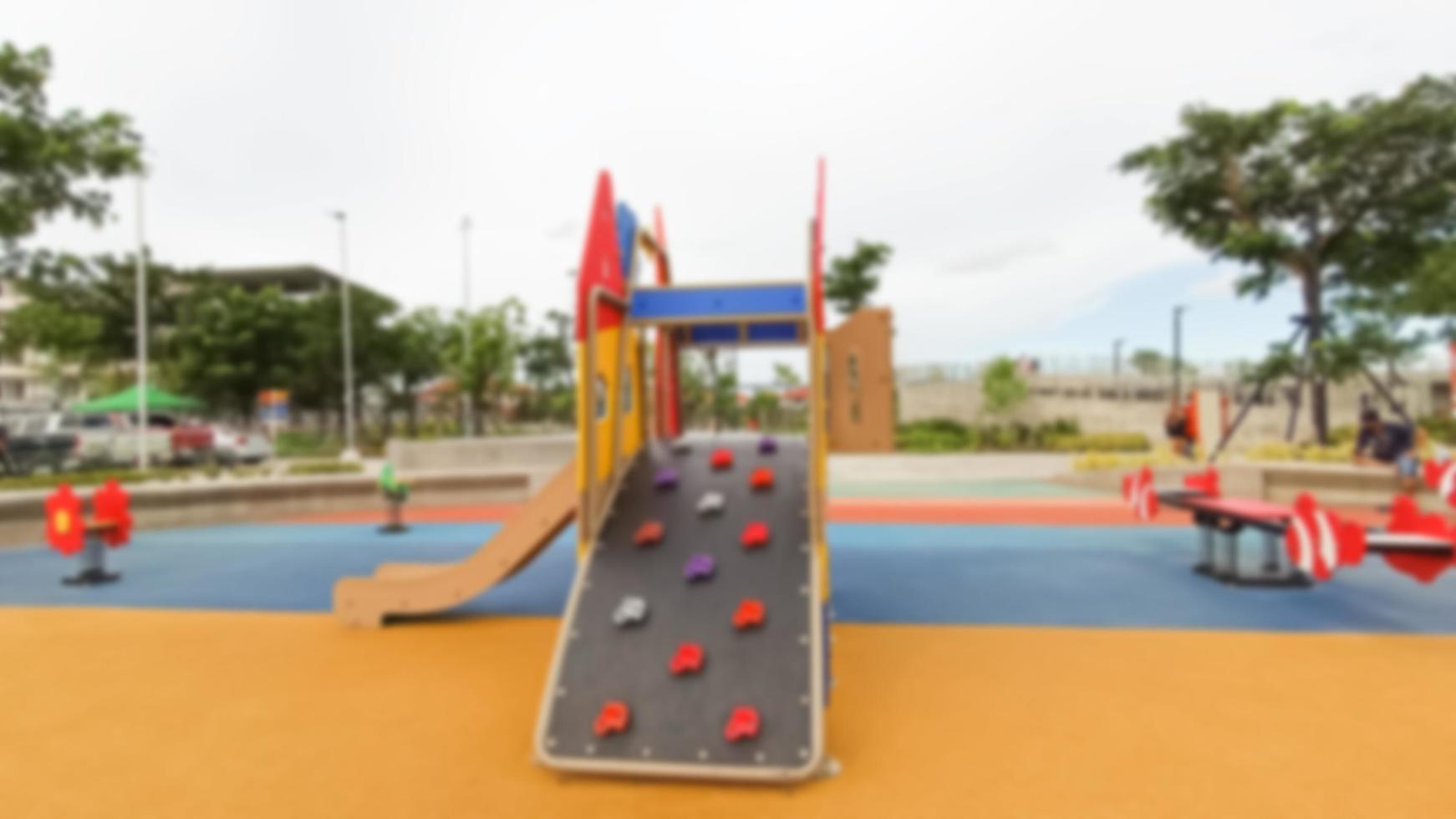 Blurred playground for children in a public park photo
