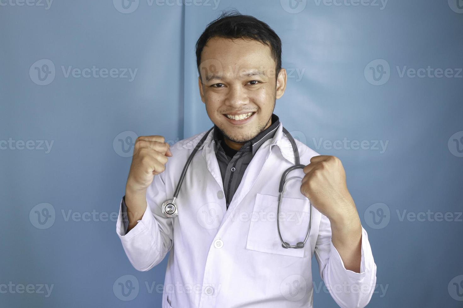 A portrait of an enthusiastic success Asian male doctor. photo