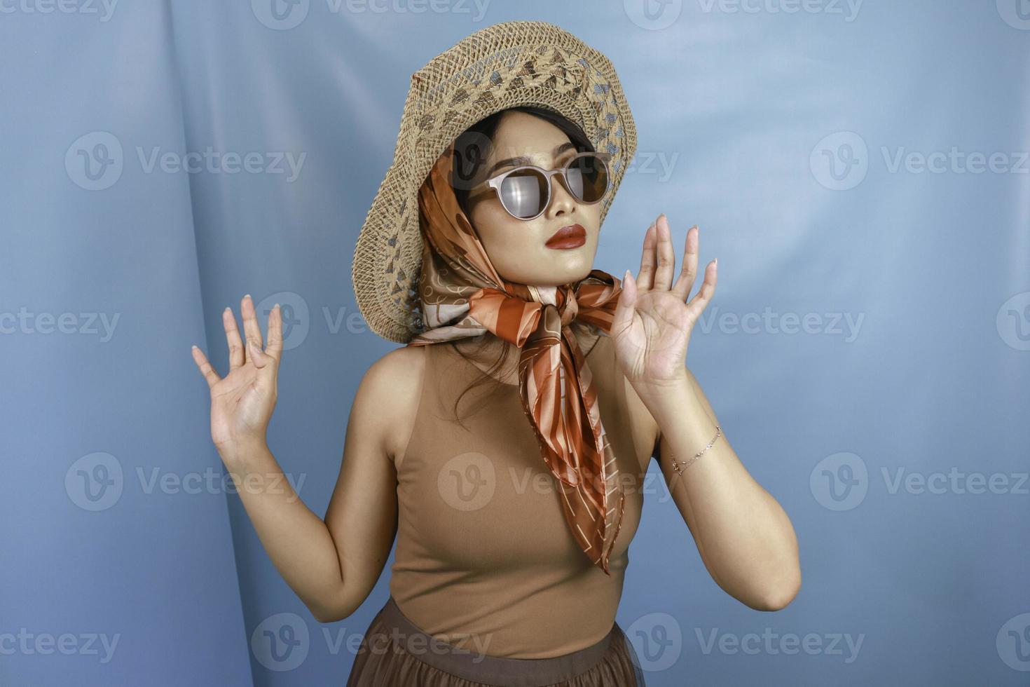 Traveling concept of a young Asian retro woman isolated by a blue background photo