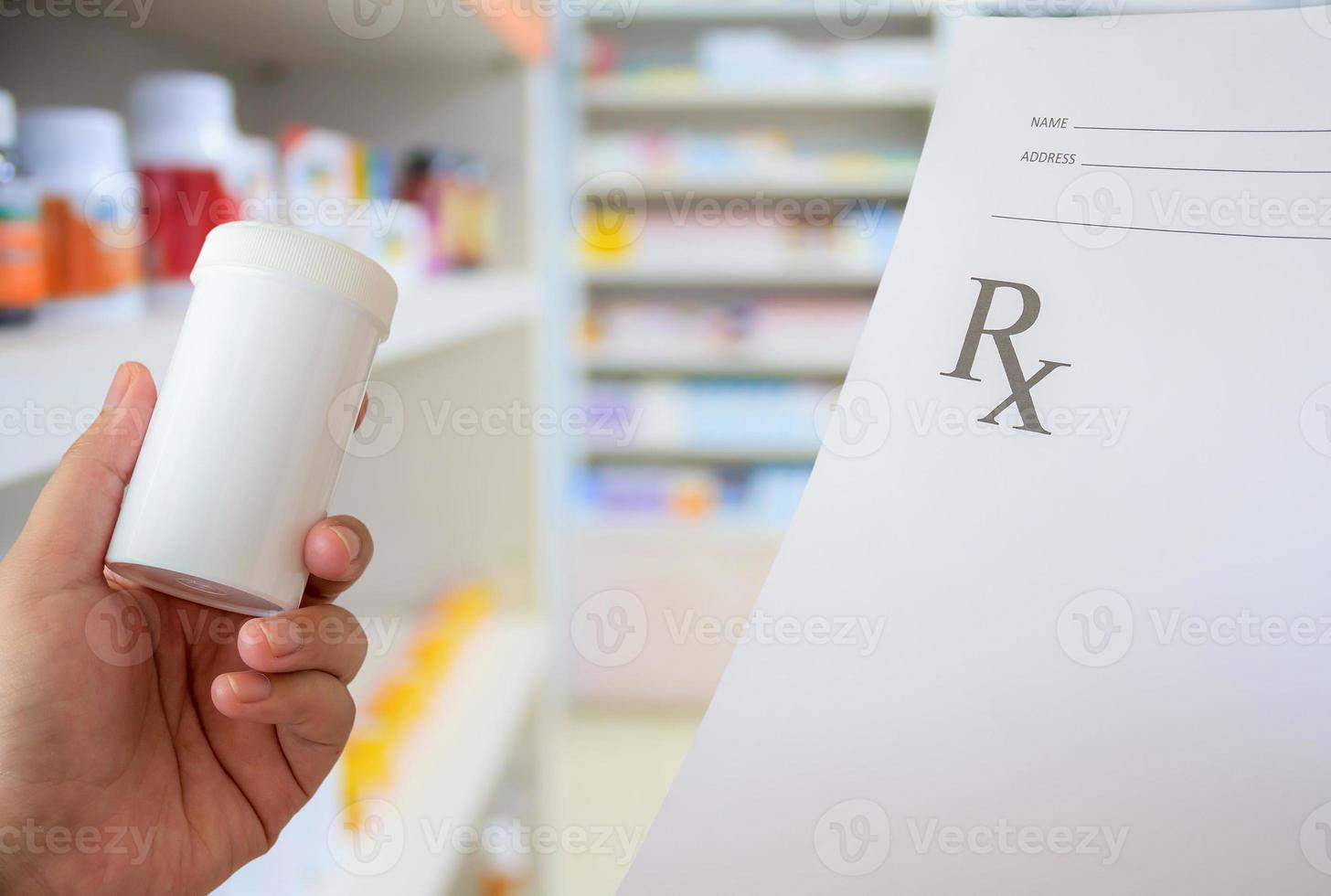 female pharmacist with prescription and medicine bottle at the pharmacy photo