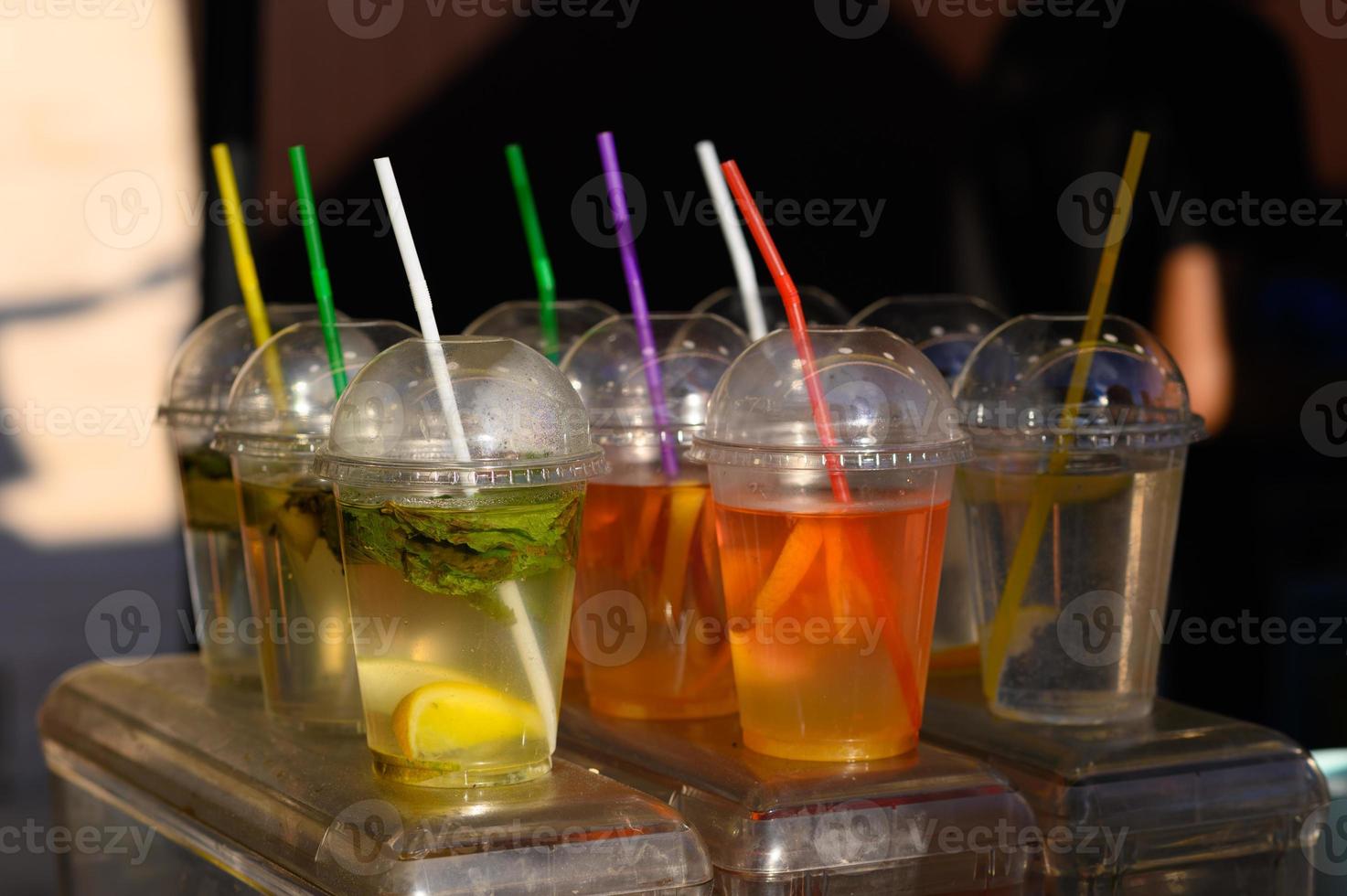 Different colors of cold water in a plastic cup. photo