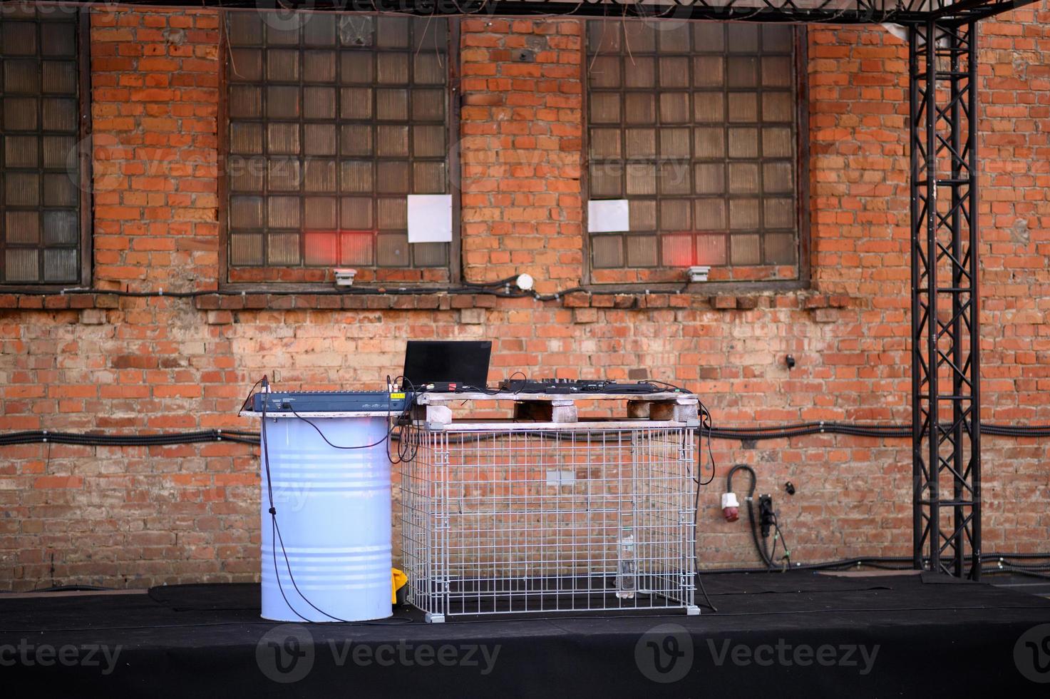 Empty DJ booth against a brick wall. Party at a closed factory photo
