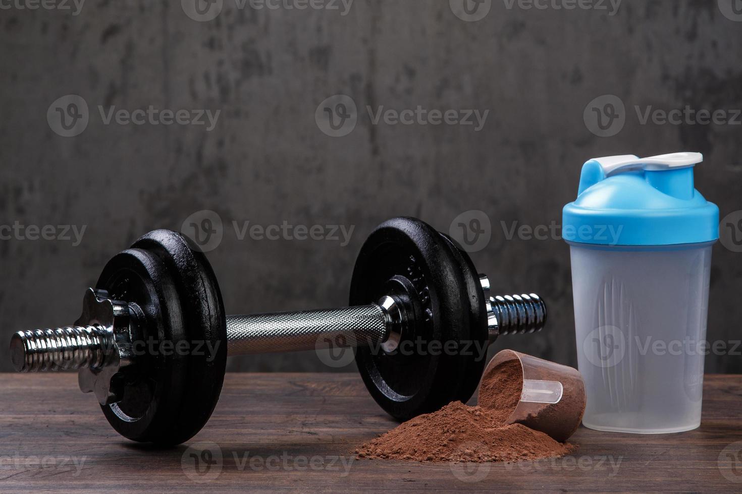 Dumbell and protein powder photo