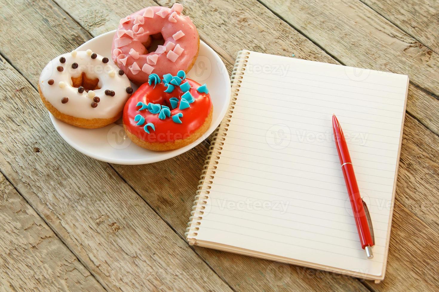 Colorful donuts and notepad photo