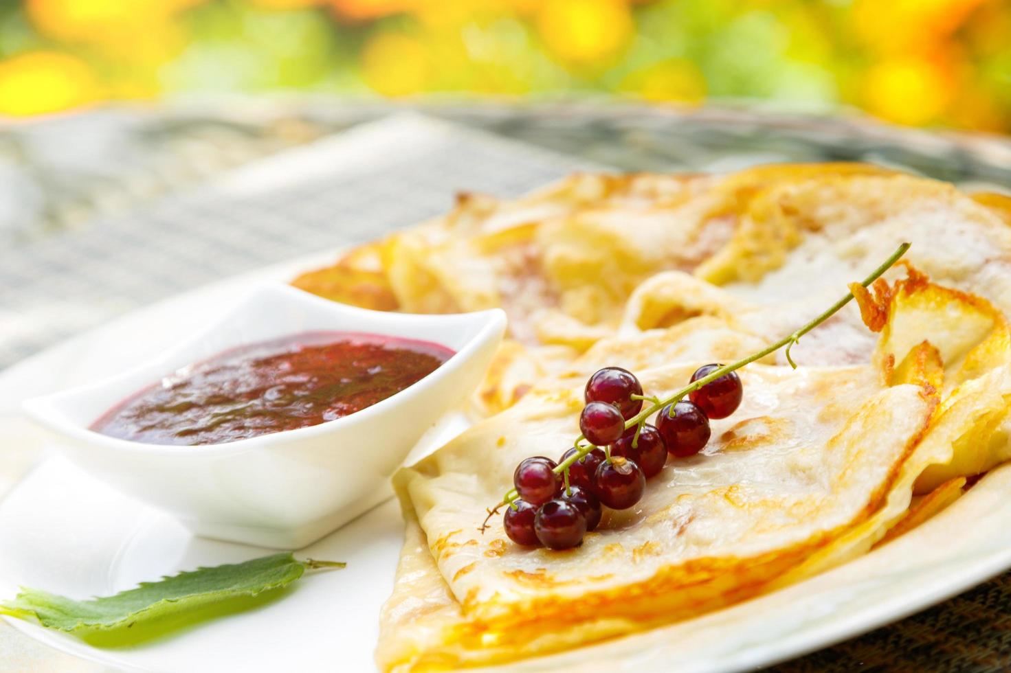 Pancakes with currant berries and jam photo