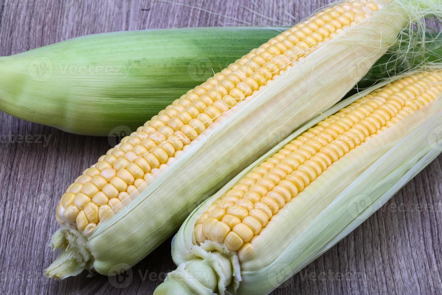 Sweet corn on wooden background photo