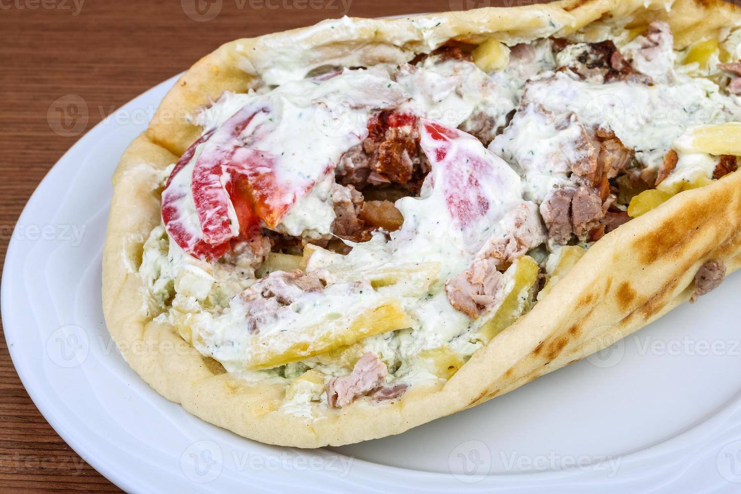 Souvlaki on the plate and wooden background photo