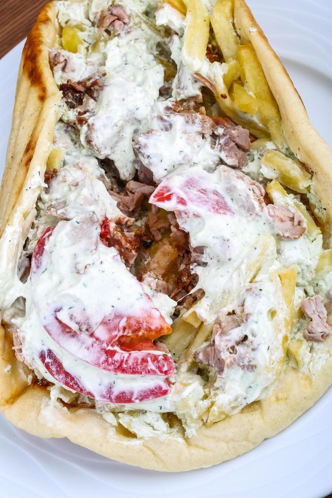 Souvlaki on the plate and wooden background photo