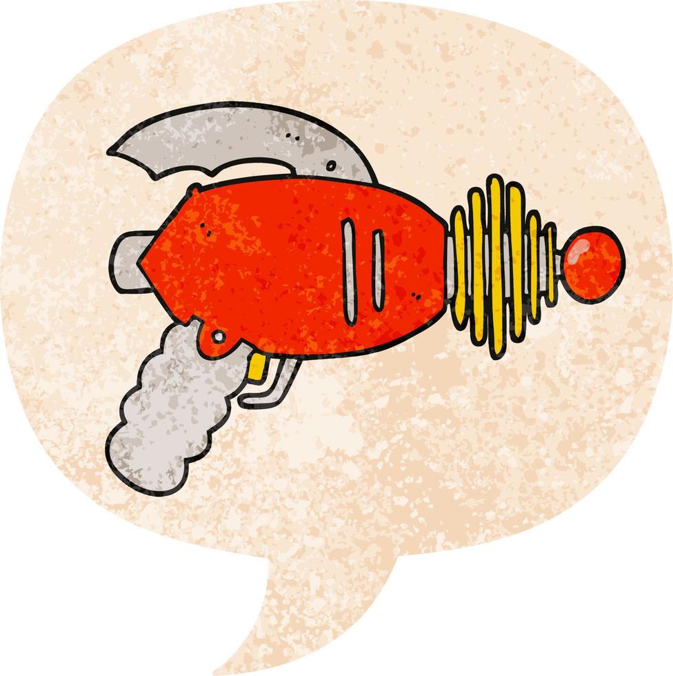 cartoon ray gun and speech bubble in retro textured style vector