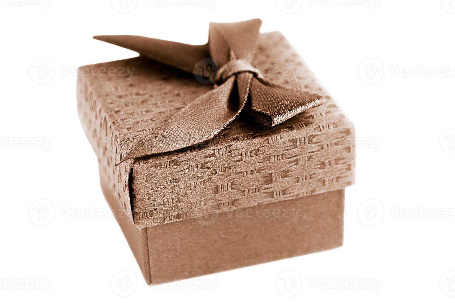 Gift box of brown color with tied ribbon in a bow isolated on white. Concept holiday and gift. photo