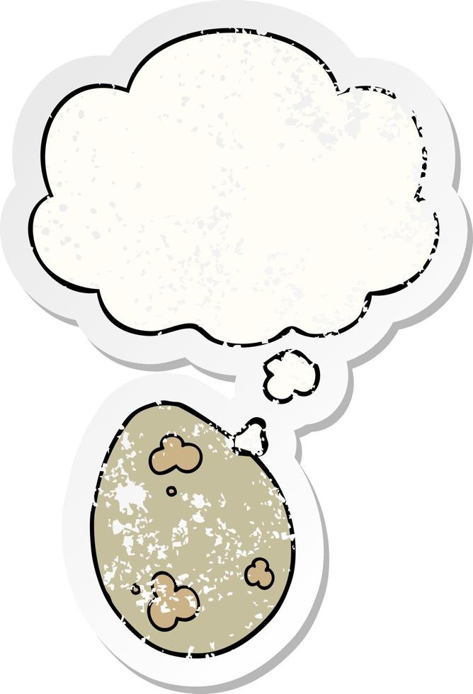 cartoon egg and thought bubble as a distressed worn sticker vector