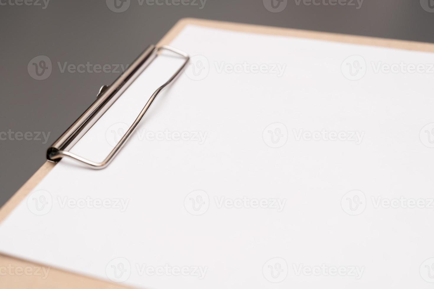 a clipboard with a white sheet of paper photo