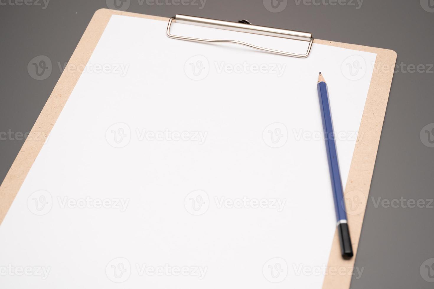 a clipboard with a white sheet of paper photo