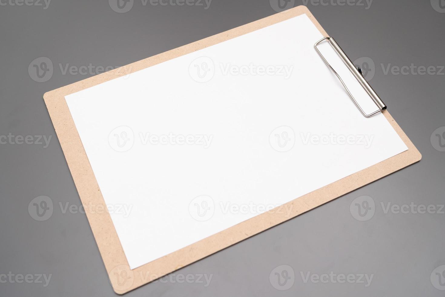 selective focus. a clipboard with a white sheet of paper photo