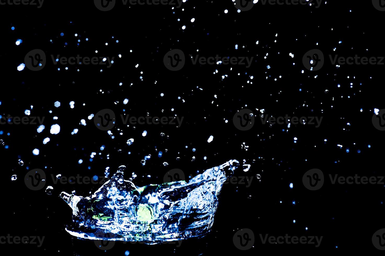 Scattered water splashes on a black background. water splash isolated on the black background photo