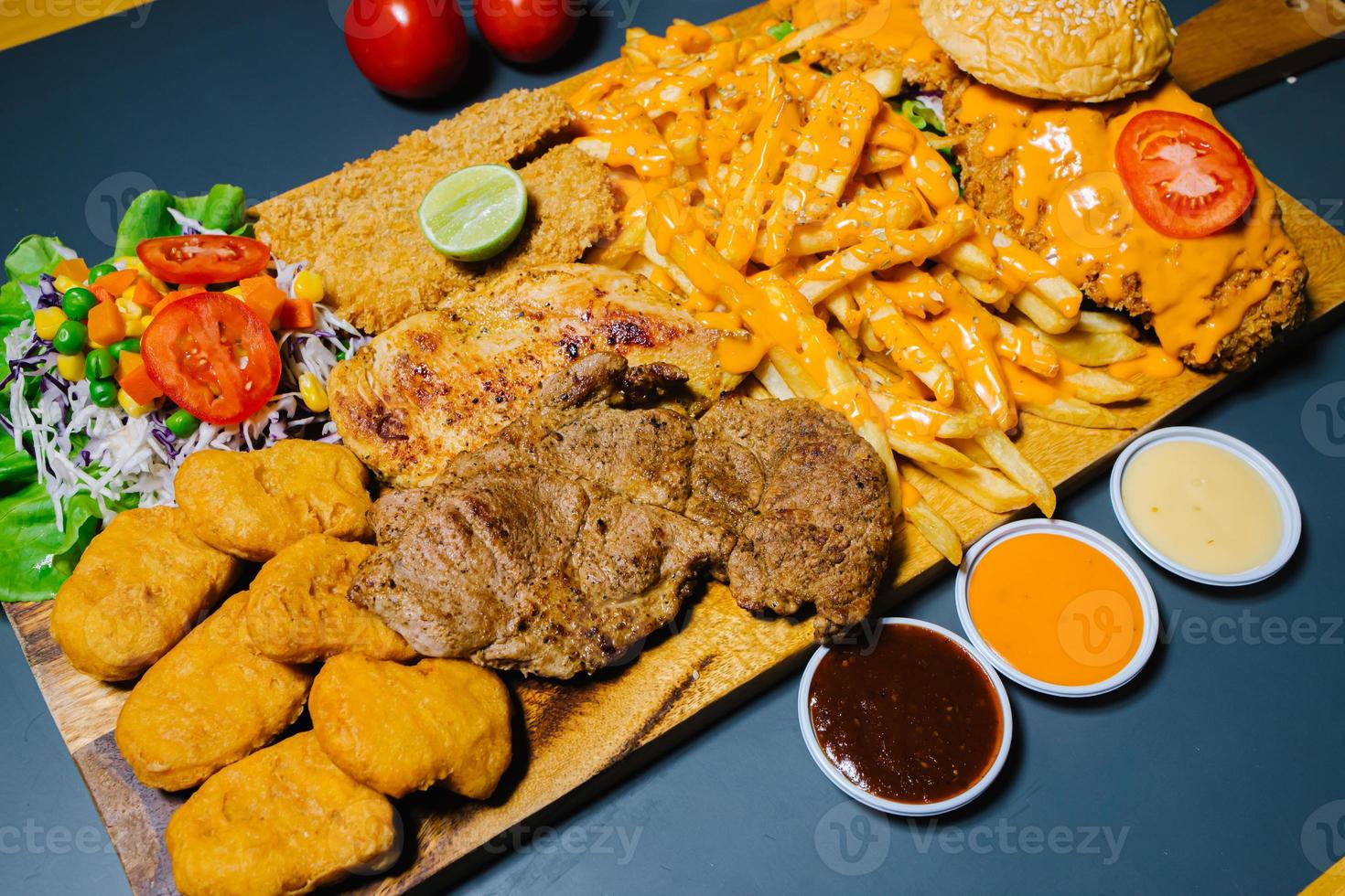 Grilled steak and lettuce, French fries on wooden plate photo