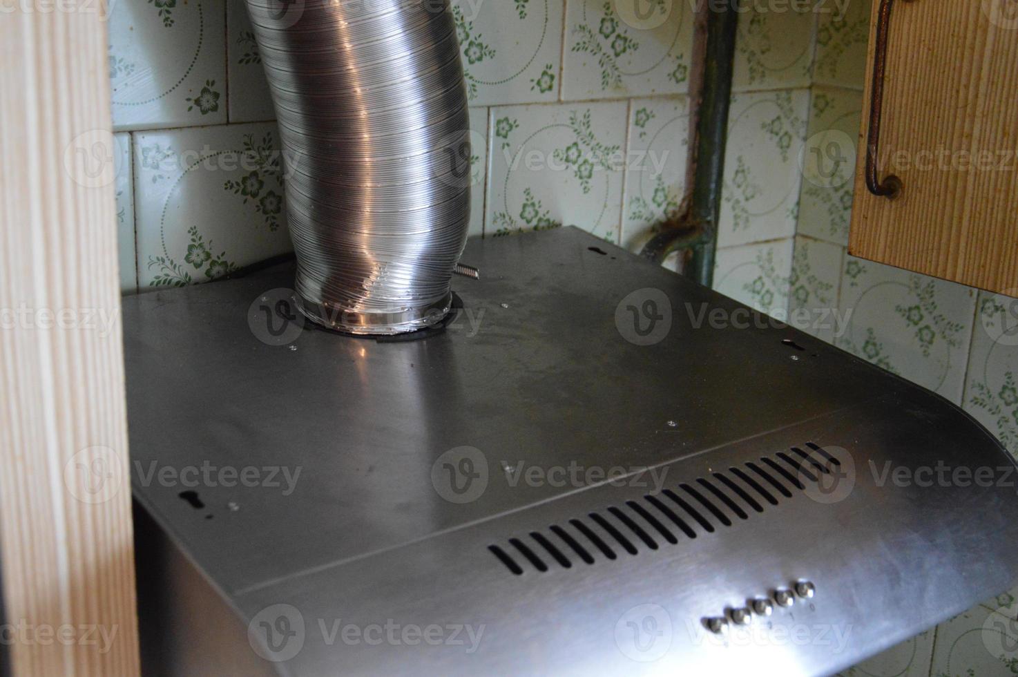 Installing a kitchen hood for ventilation photo