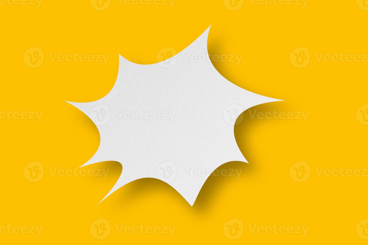 White paper in speech bubble shape set against yellow background. photo