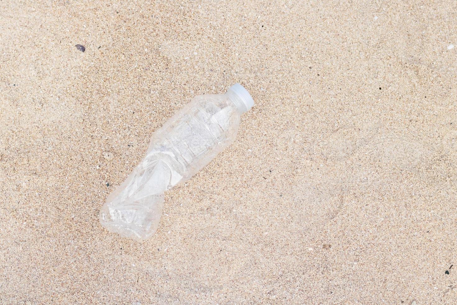 Plastic bottles, garbage on the sand photo