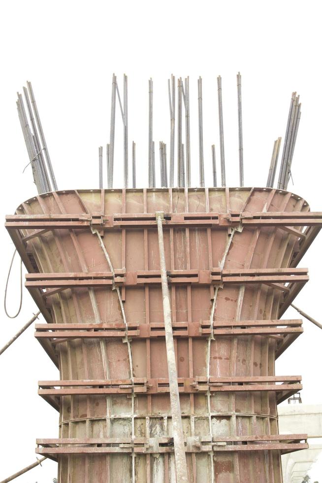 Construction and casting of concrete piles to support the weight of an expressway bridge in rural Thailand on a separate white background. photo