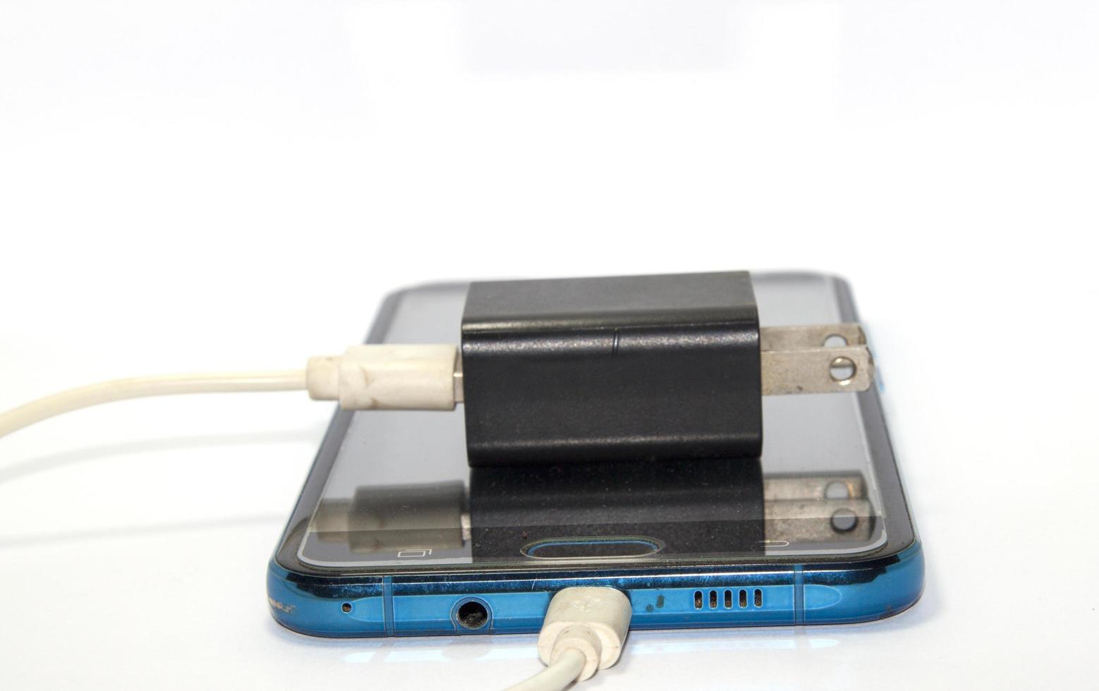 mobile charger Black and white on a white background It is modern equipment and technology. . Shot in my home studio with lights and flash for clarity. photo