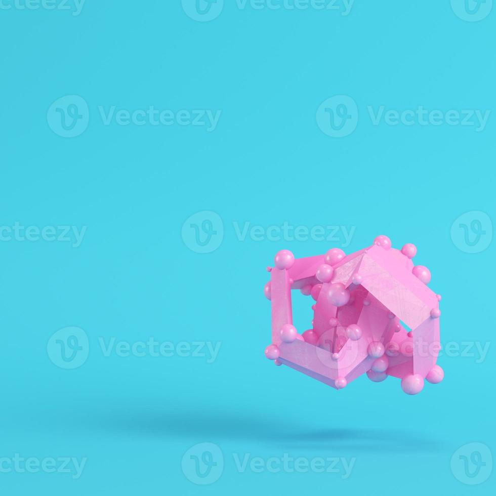 Pink abstract low poly shape on bright blue background in pastel colors photo