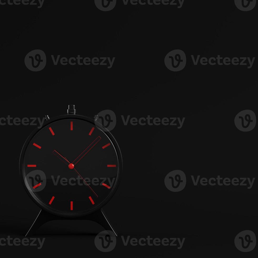 Black alarm clock on dark background. Minimalism concept. photo
