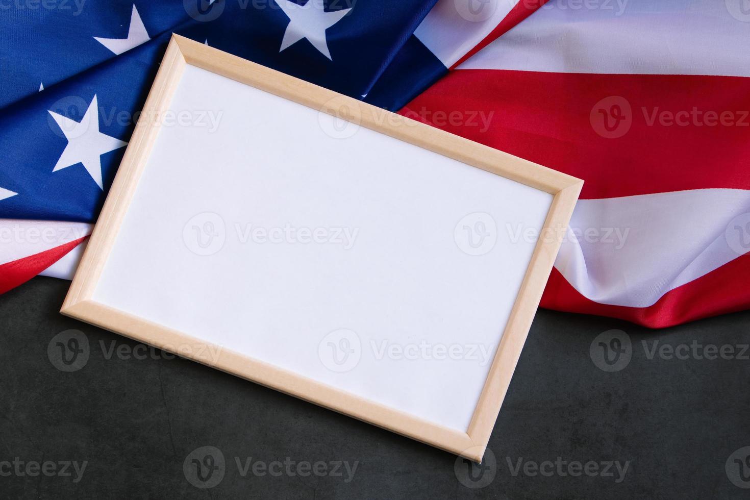 Empty frame for text and American flag on dark background. Concept of celebrating national holidays - Independence Day, Memorial Day or Labor Day. photo