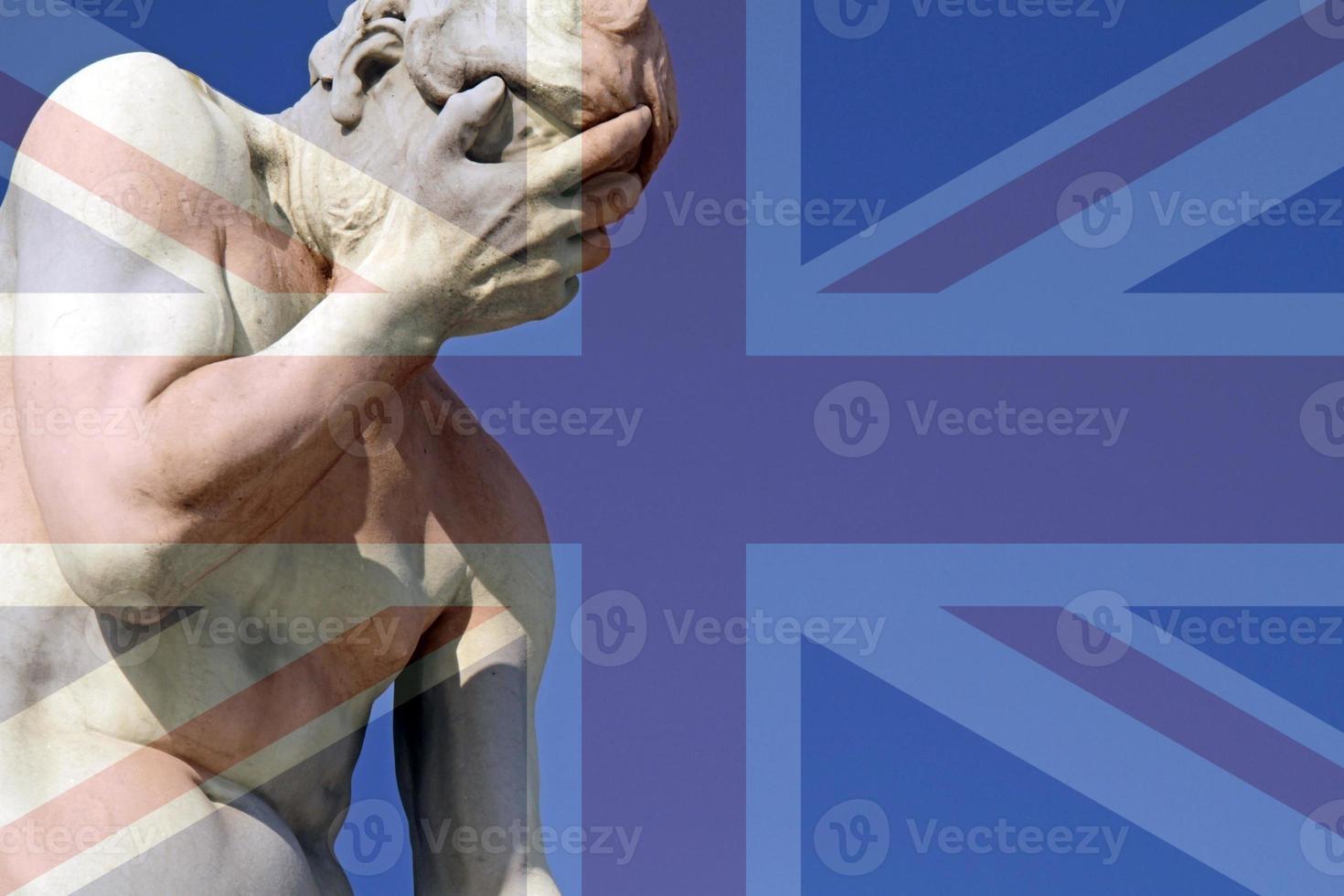 Union Jack over a statue with its head in its hands photo