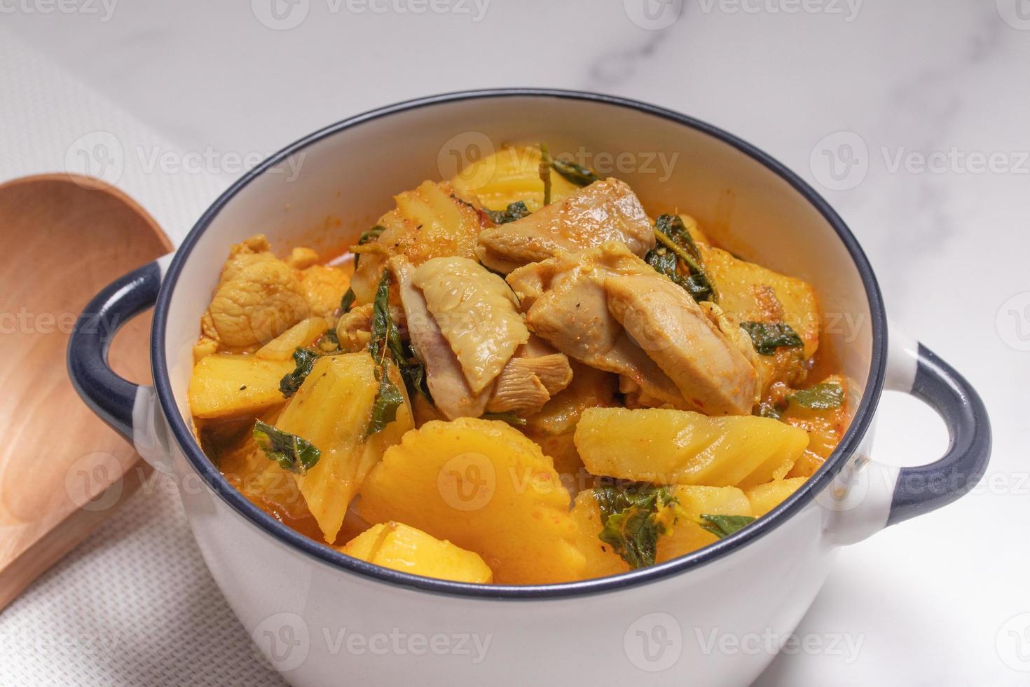 Chicken and Potato Curry with Basil Leaves in a Thai White Bowl photo