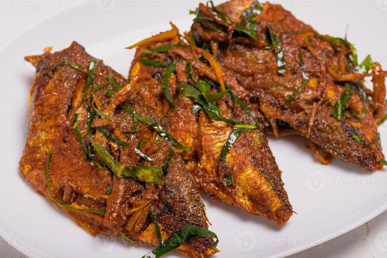 Fried fish with Thai red curry paste photo