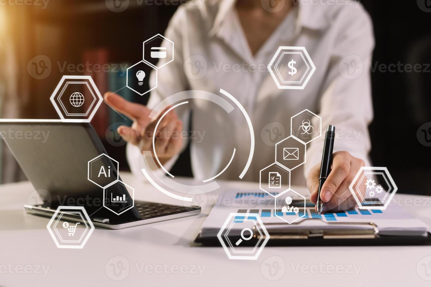 Hands using mobile phone in modern office with laptop photo