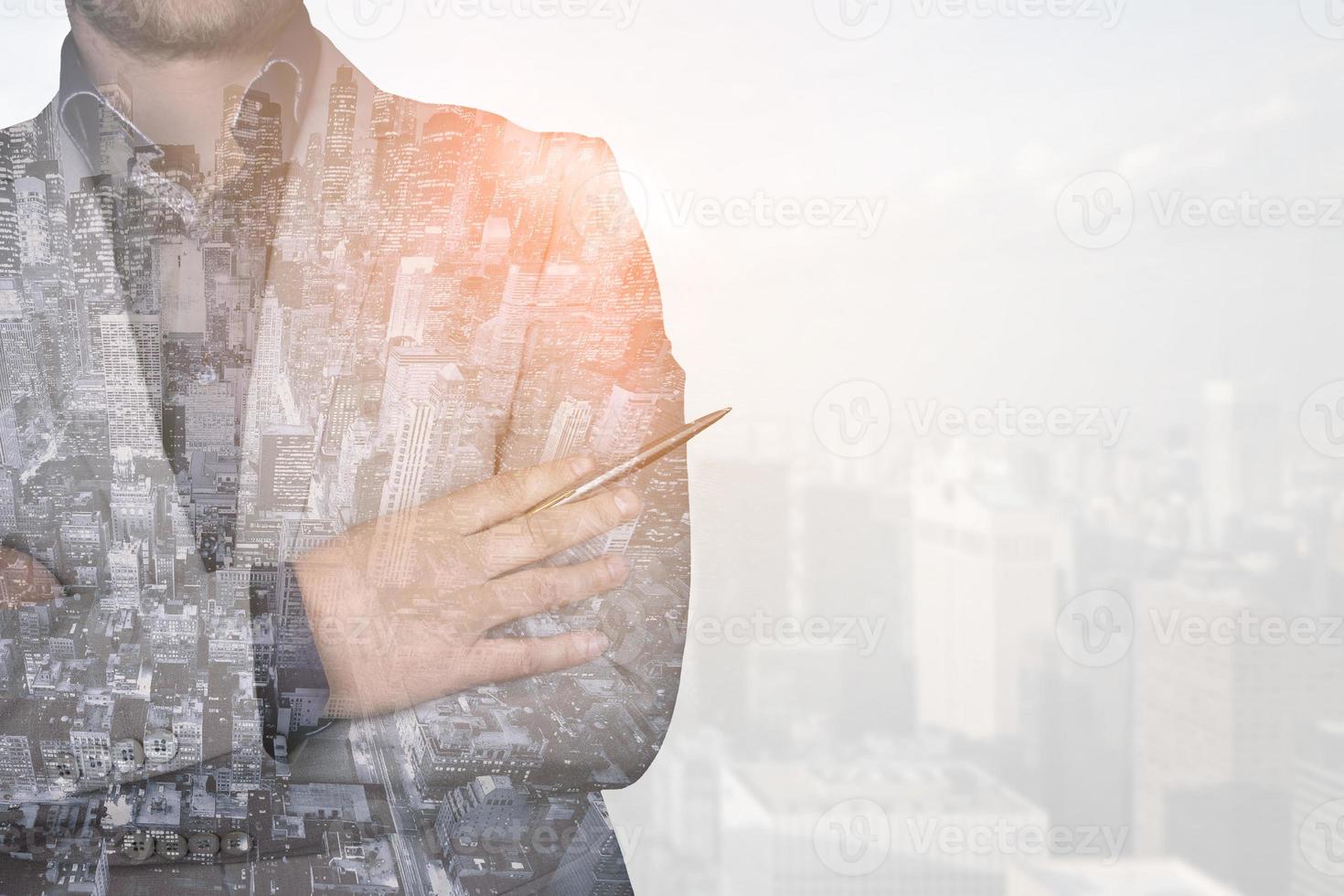 Double exposure image of a business man against a modern city background. The concept of the future of business and communication technologies. photo