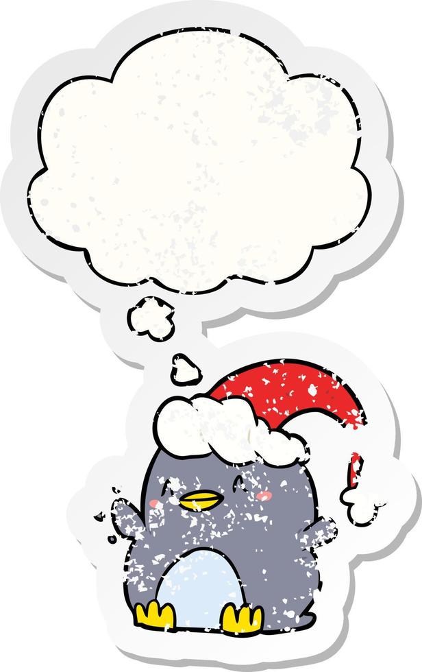 cartoon penguin wearing christmas hat and thought bubble as a distressed worn sticker vector