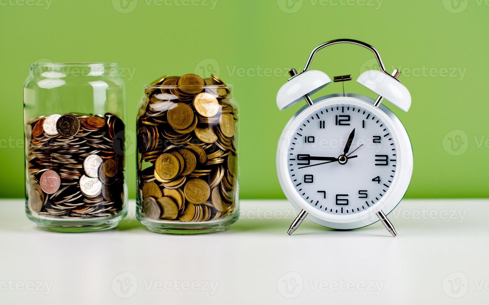 Money in a glass jar of money saved for financial errands. and money for building a house in the future Money and Time Savings Ideas photo