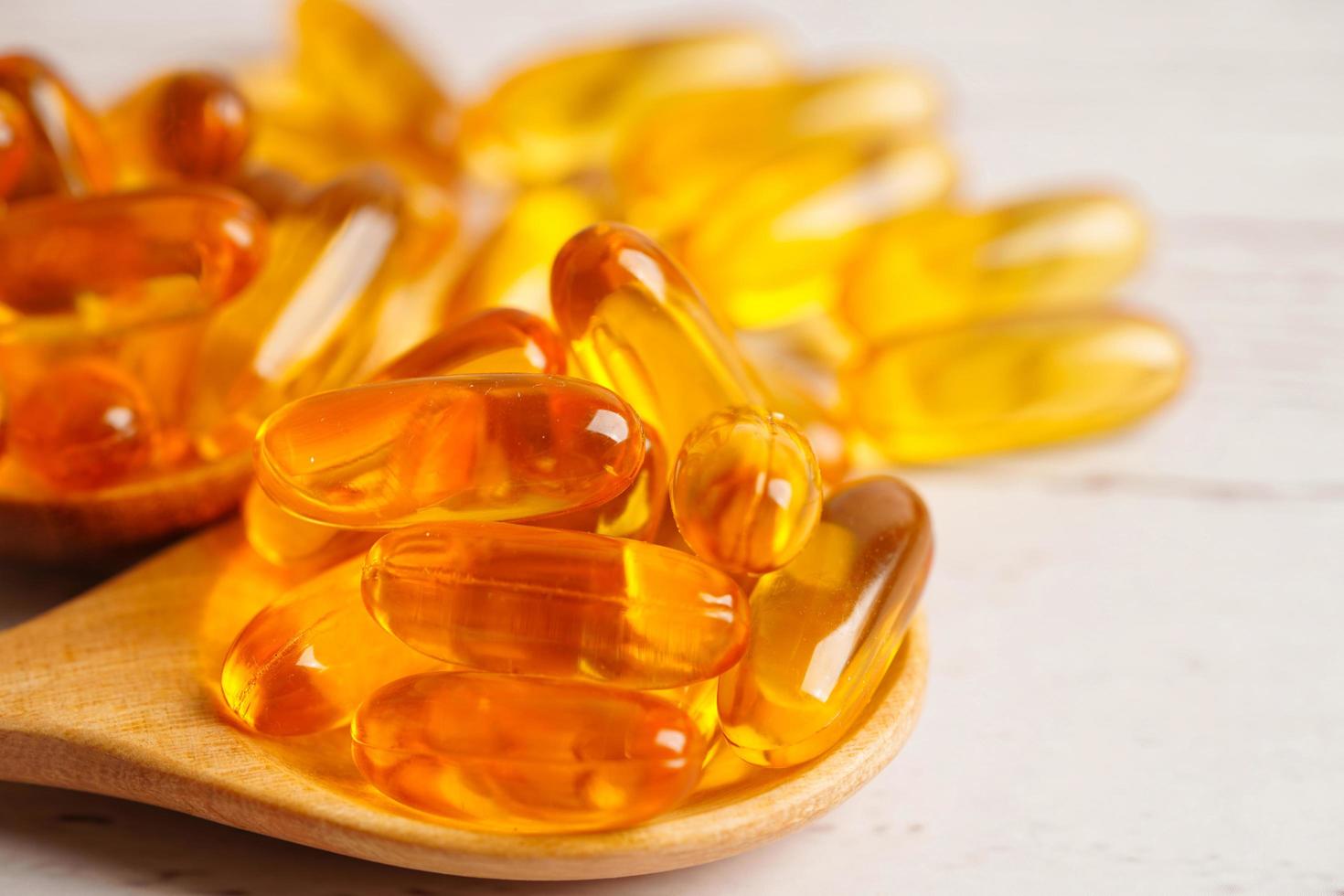 Fish oil or Cod liver oil gel in capsules with omega 3 vitamins, supplementary healthy food photo