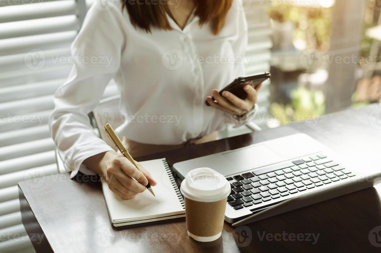 businessman hand working with new modern computer and writing on the notepad strategy diagram as concept morning light photo