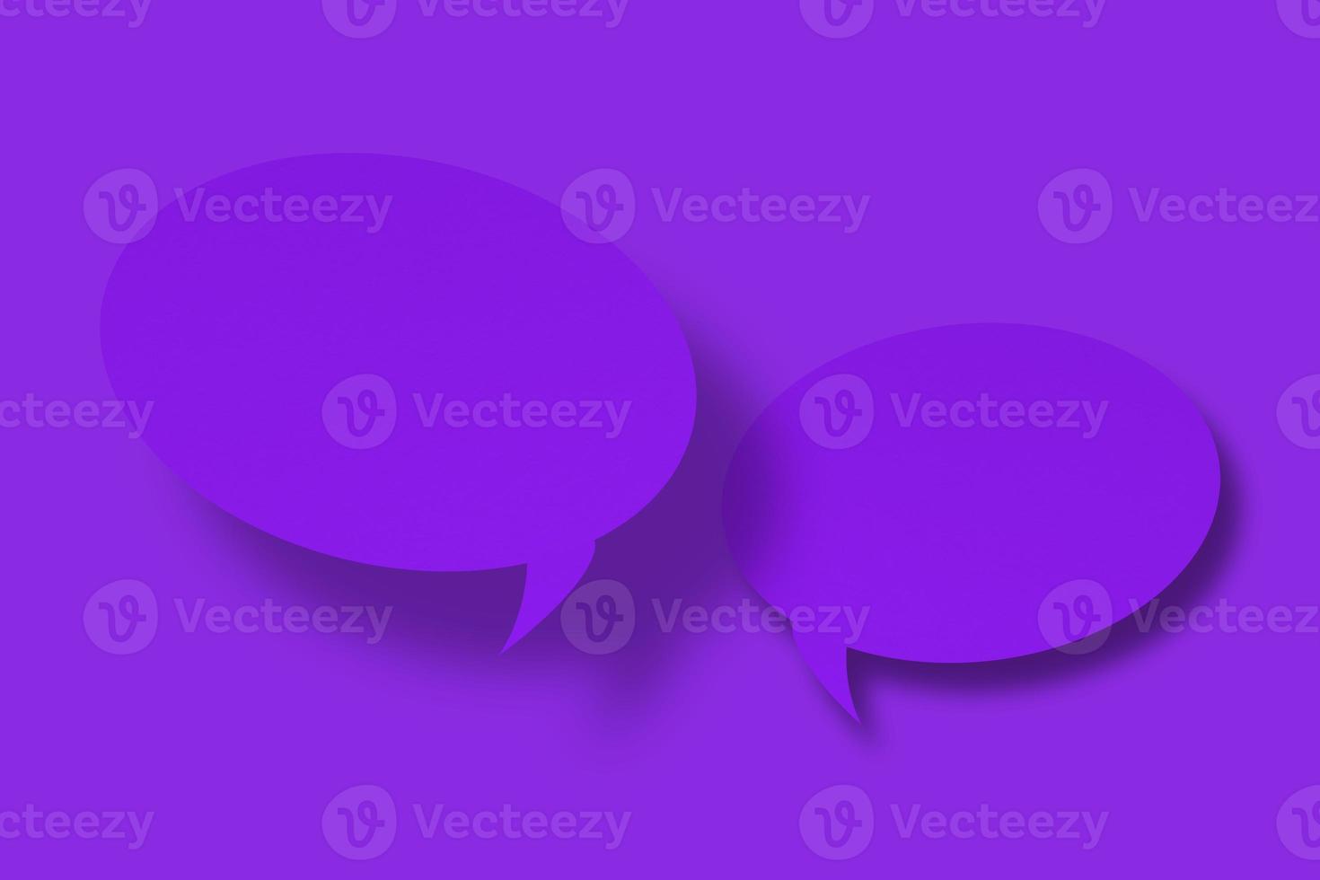 Purple paper in the shape of speech bubbles against a purple background. Communication bubbles. photo