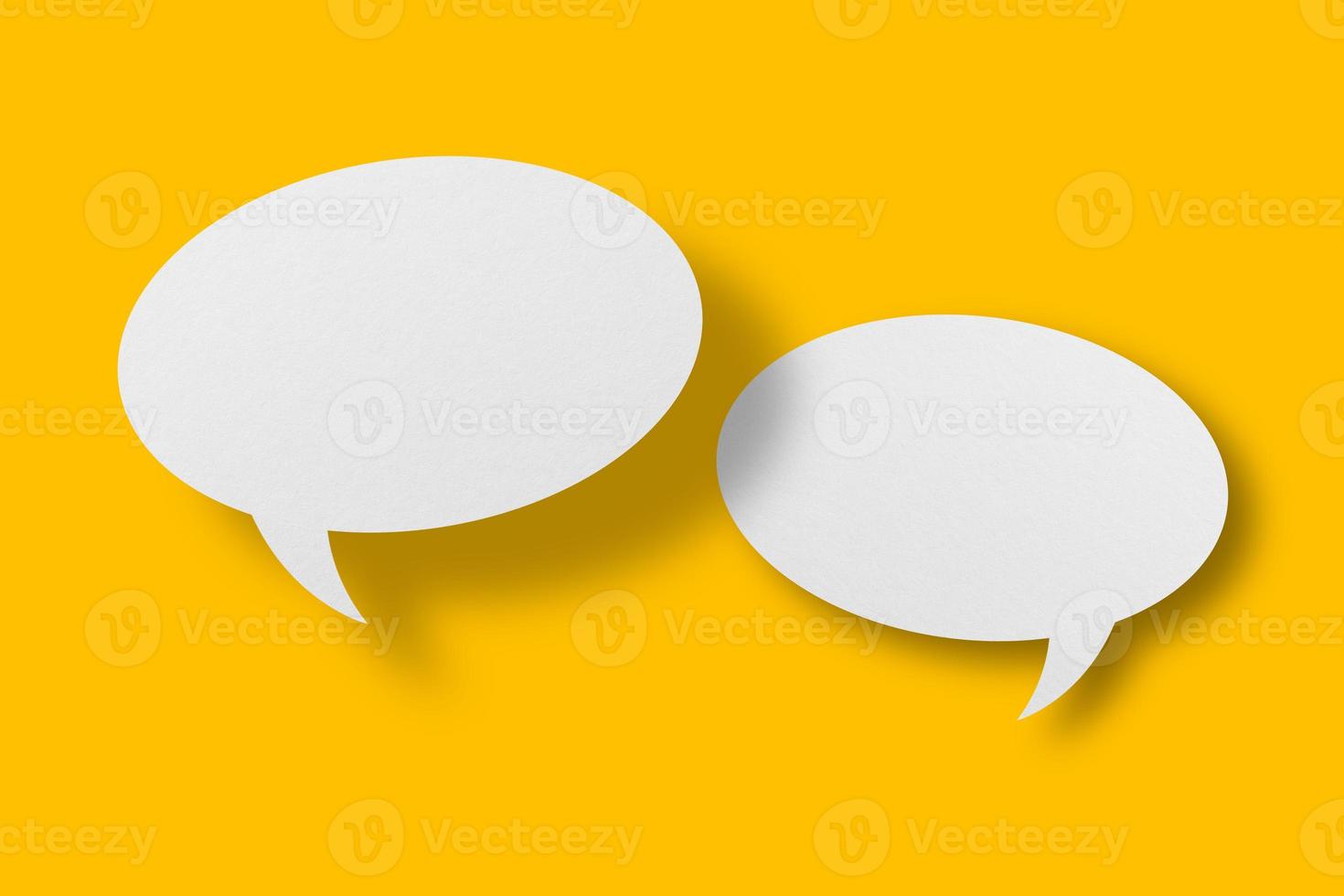 White paper in speech bubble shape set against yellow background. photo