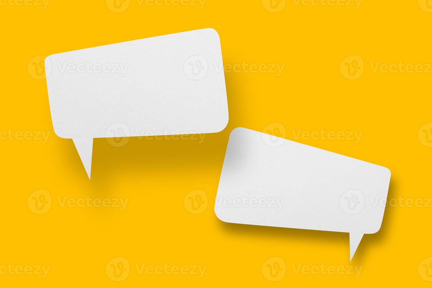 White paper in speech bubble shape set against yellow background. photo