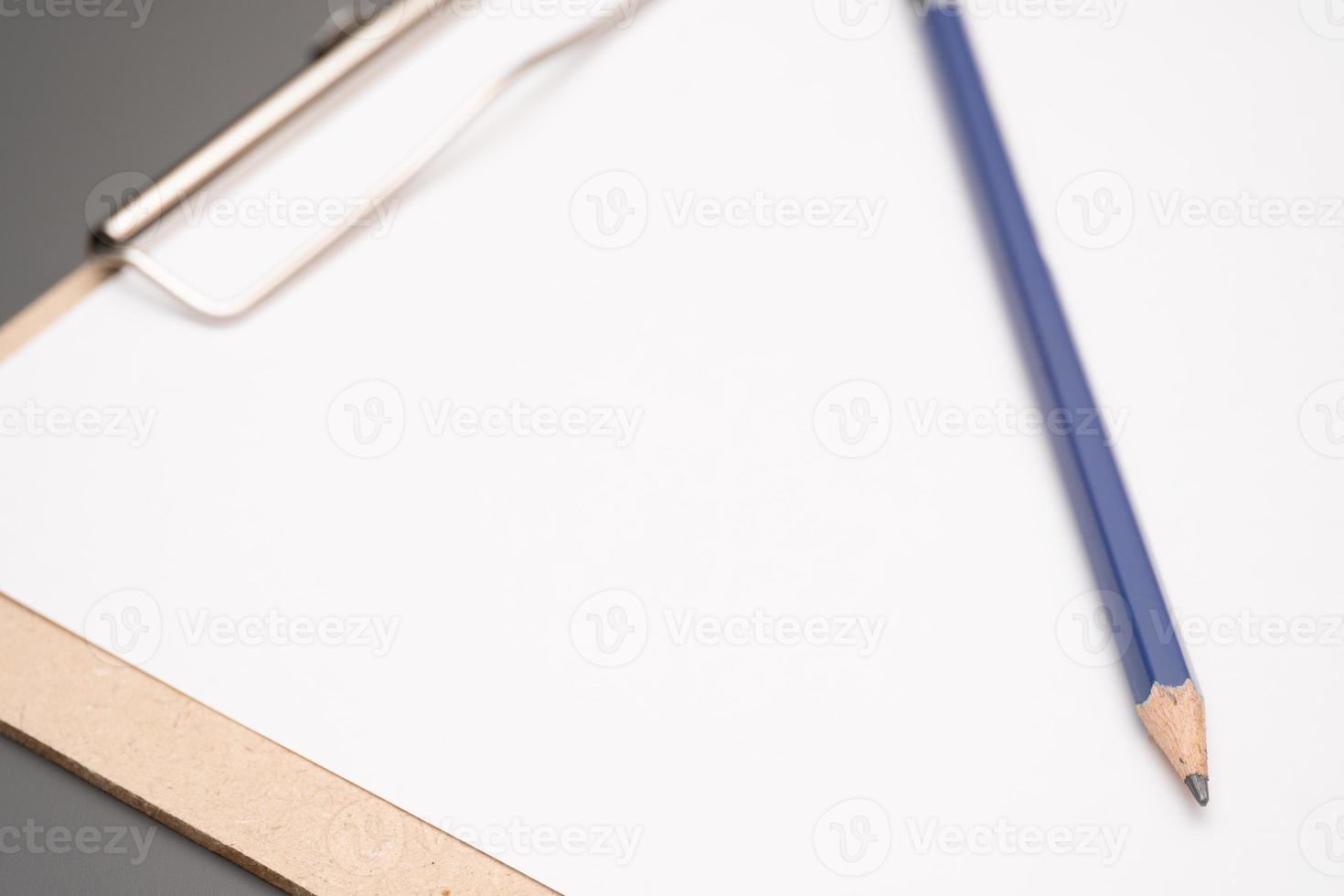 a clipboard with a white sheet of paper photo