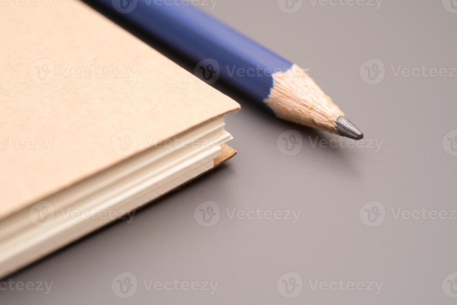 closed blank craft paper cover notebook with pencil. Office and study items close-up. photo