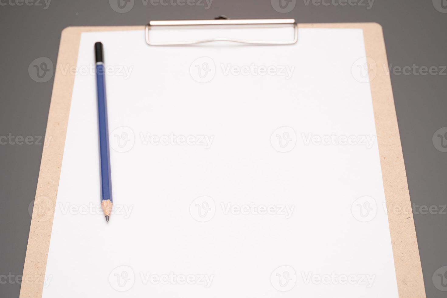 selective focus. a clipboard with a white sheet of paper photo