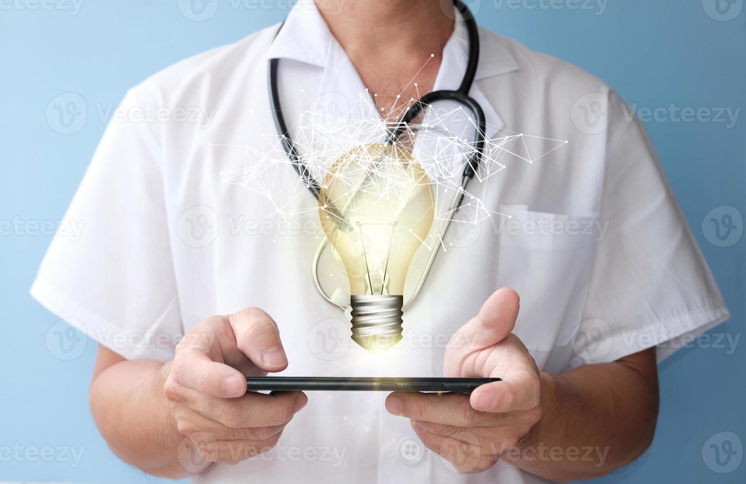 Idea concept with innovation and inspiration, revolutionary technology in science and communication, hands holding light bulb photo