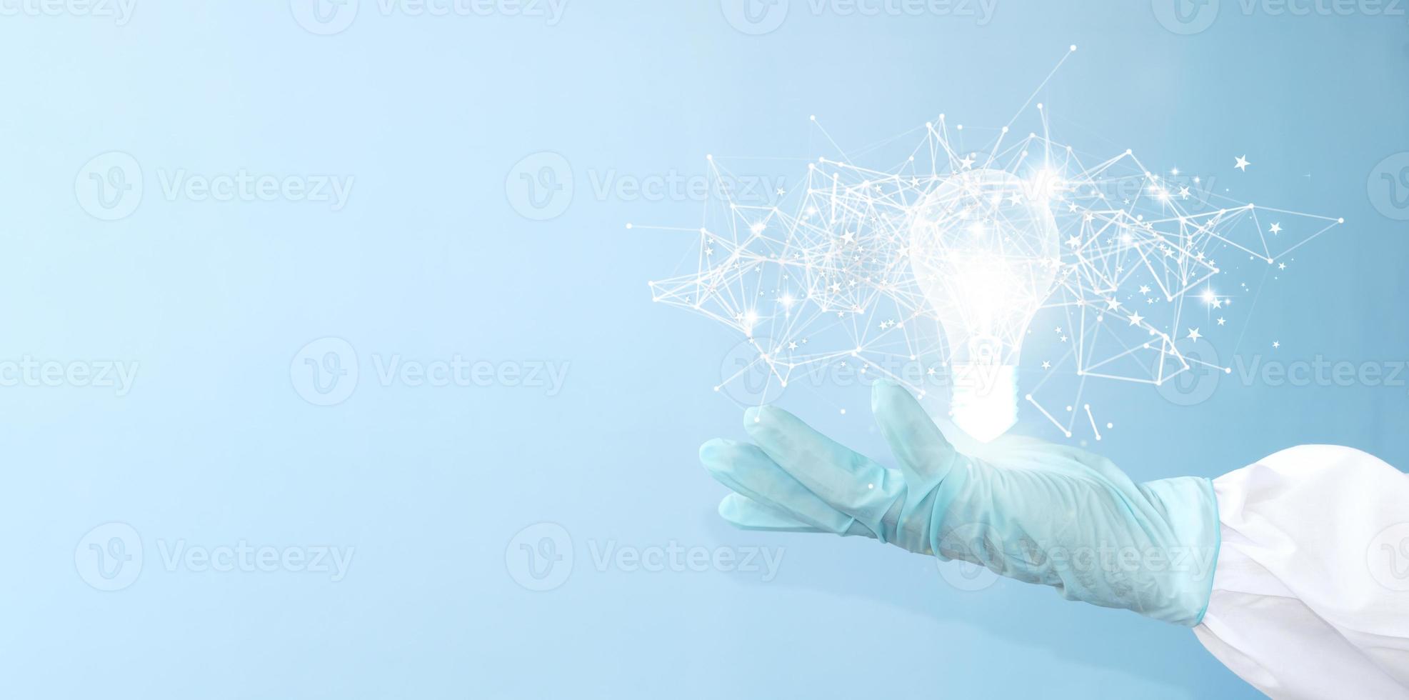 Idea concept with innovation and inspiration, revolutionary technology in science and communication, hands holding light bulb photo