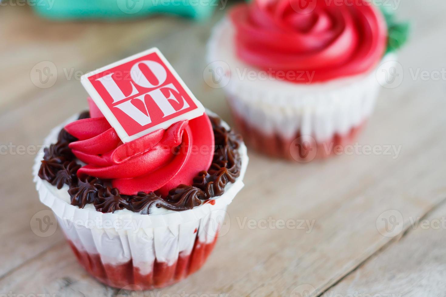 red rose cupcakes on wooden table photo