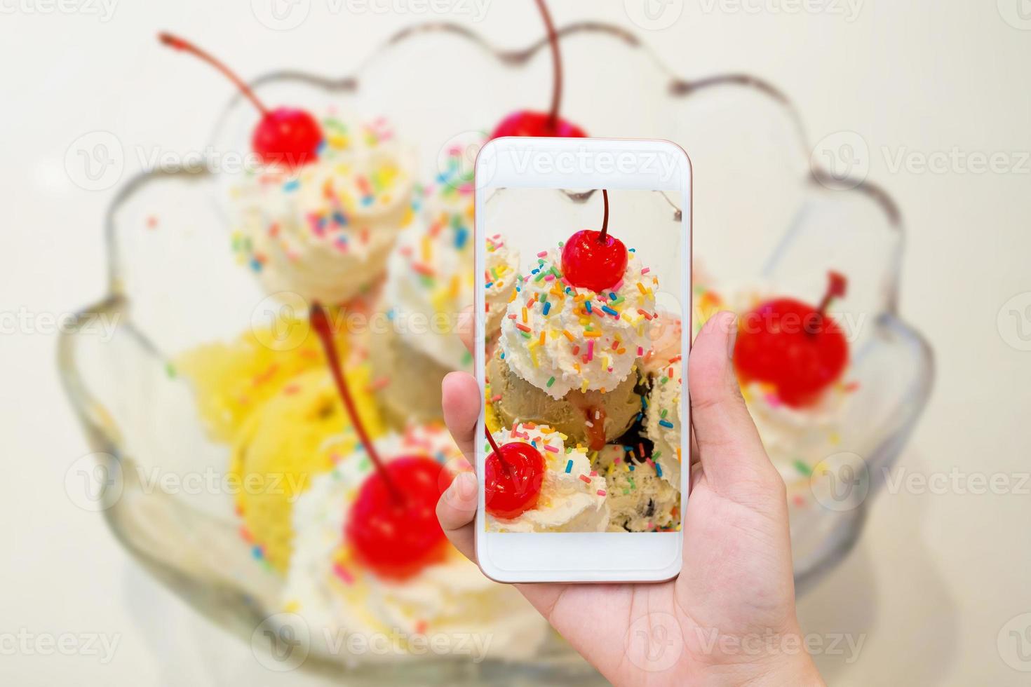 hand hold smart phone and take photo on ice cream